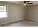A cozy bedroom featuring fresh paint and a large window offering ample sunlight at 209 Reade Dr, Roxboro, NC 27573