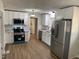Modern kitchen with white cabinets, stainless steel appliances, granite counters, and eat-in breakfast nook at 209 Reade Dr, Roxboro, NC 27573