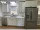 Bright modern kitchen featuring stainless steel appliances, white cabinets, granite counters, and modern sink fixtures at 209 Reade Dr, Roxboro, NC 27573