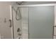 Bathroom shower featuring glass sliding doors, shower head, and mounted fixtures at 209 Reade Dr, Roxboro, NC 27573