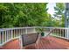 Back deck with seating offers a serene outdoor space surrounded by lush greenery at 2310 Woodbury Dr, Hillsborough, NC 27278