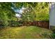 Fenced-in backyard with lush lawn and mature trees offering privacy at 2310 Woodbury Dr, Hillsborough, NC 27278