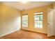 Neutral bedroom with hardwood floors, bright natural light from the two large windows at 2310 Woodbury Dr, Hillsborough, NC 27278