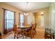 Cozy dining room featuring a wood table, chandelier, and large windows at 2310 Woodbury Dr, Hillsborough, NC 27278