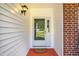 Welcoming front door with sidelight, and a storm door at 2310 Woodbury Dr, Hillsborough, NC 27278