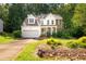 Charming home featuring a landscaped front yard, attached garage, and classic architectural details at 2310 Woodbury Dr, Hillsborough, NC 27278