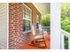 Comfortable front porch with rocking chairs and brick detail at 2310 Woodbury Dr, Hillsborough, NC 27278