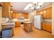 Bright kitchen with stainless steel appliances, central island, and wood cabinetry at 2310 Woodbury Dr, Hillsborough, NC 27278