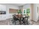 Bright dining area with sliding glass doors, leading to outdoor space and a table for six at 2558 Summersby Dr, Mebane, NC 27302