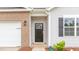 Up-close exterior showcasing the front door, brick accents, and window with a dark shutter at 2558 Summersby Dr, Mebane, NC 27302