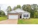 Charming single-Gathering home features a brick-accented garage, manicured lawn, and inviting front entrance at 2558 Summersby Dr, Mebane, NC 27302