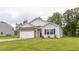 Well-maintained single-Gathering home features a lush lawn, side yard, and classic architectural details at 2558 Summersby Dr, Mebane, NC 27302