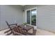 Relaxing patio area with wooden chairs, a small table, and sliding glass doors to let in ample natural light at 2558 Summersby Dr, Mebane, NC 27302