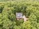 Aerial view of the home surrounded by lush greenery, with driveway and manicured lawns visible at 2617 Jones Ferry Rd, Chapel Hill, NC 27516