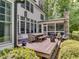 Inviting back deck with outdoor dining, screened porch, and views of the lush backyard at 2617 Jones Ferry Rd, Chapel Hill, NC 27516