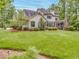 Expansive backyard with a well-manicured lawn and a charming back exterior, perfect for outdoor entertaining at 2617 Jones Ferry Rd, Chapel Hill, NC 27516