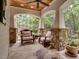 Relaxing outdoor porch area with comfortable seating, flagstone flooring, and stone pillars, perfect for enjoying the view at 2617 Jones Ferry Rd, Chapel Hill, NC 27516