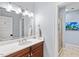 Bathroom featuring a marble countertop, wood cabinet, and framed mirror at 2617 Jones Ferry Rd, Chapel Hill, NC 27516