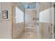 Walk-in shower with tile surround, glass door, and window at 2617 Jones Ferry Rd, Chapel Hill, NC 27516