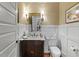 Cozy half-bath featuring detailed wall trim, marble countertop, and classic fixtures at 2617 Jones Ferry Rd, Chapel Hill, NC 27516
