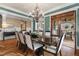 Formal dining room with hardwood floors, chandelier, and access to the outdoor patio at 2617 Jones Ferry Rd, Chapel Hill, NC 27516