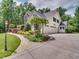 Stunning home exterior boasting a white facade, a three-car garage and professional landscaping at 2617 Jones Ferry Rd, Chapel Hill, NC 27516