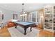 Game room with pool table, natural light, and built-in bookcase at 2617 Jones Ferry Rd, Chapel Hill, NC 27516