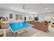 Spacious game room featuring a ping pong table, basketball hoop, plush seating, and ample natural light at 2617 Jones Ferry Rd, Chapel Hill, NC 27516