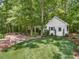 Quaint guest house surrounded by mature trees and lush landscaping, set back from the main house at 2617 Jones Ferry Rd, Chapel Hill, NC 27516