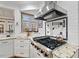 Kitchen with stainless steel range, white cabinets, granite countertops, and tile backsplash at 2617 Jones Ferry Rd, Chapel Hill, NC 27516