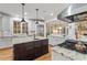 Bright kitchen featuring white cabinetry, a center island, granite countertops, and stainless appliances at 2617 Jones Ferry Rd, Chapel Hill, NC 27516