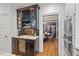 Kitchen features custom wet bar with wine cooler, dark wood cabinets, and granite countertop at 2617 Jones Ferry Rd, Chapel Hill, NC 27516