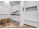 Mudroom with custom built-ins, storage cabinets, and tile flooring at 2617 Jones Ferry Rd, Chapel Hill, NC 27516