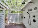 Serene outdoor shower with a white pergola, multiple shower heads, and lush greenery for privacy at 2617 Jones Ferry Rd, Chapel Hill, NC 27516