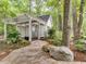 Private outdoor shower nestled among trees, featuring a pergola, stone pathway, and lush landscaping at 2617 Jones Ferry Rd, Chapel Hill, NC 27516