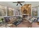 Cozy screened porch with a stone fireplace, comfortable seating, and wooded views at 2617 Jones Ferry Rd, Chapel Hill, NC 27516