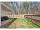 Fenced backyard with a covered patio and a small grassy area at 290 Forest Meadow Ln, Franklinton, NC 27525