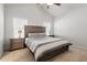 Comfortable bedroom features two windows, a ceiling fan, and an inviting bed with side tables and lamps at 290 Forest Meadow Ln, Franklinton, NC 27525