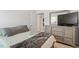 Cozy bedroom featuring a dresser with a mirror and a comfortable bed with soft, neutral-toned bedding at 290 Forest Meadow Ln, Franklinton, NC 27525