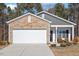 Charming single-story home with a stone facade, two-car garage, and well-maintained landscaping at 290 Forest Meadow Ln, Franklinton, NC 27525