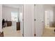 Hallway with open closet doors leading into a bedroom with desk and chair at 290 Forest Meadow Ln, Franklinton, NC 27525
