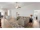 Open-concept living room showcasing a comfortable sectional, neutral rug, and seamless flow to the kitchen at 290 Forest Meadow Ln, Franklinton, NC 27525