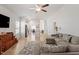 Bright living room featuring wood floors, a sectional sofa, and an open layout connecting to the modern kitchen at 290 Forest Meadow Ln, Franklinton, NC 27525