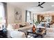 Bright and airy living room featuring a modern white sofa, stylish chairs, and contemporary decor at 320 Catheys Crk Cir, Wendell, NC 27591