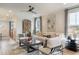 Cozy living room with a white sofa, stylish chairs, modern decor, and plenty of natural light at 320 Catheys Crk Cir, Wendell, NC 27591
