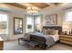 Serene bedroom with tray ceilings, a king-size bed, a large mirror, and soft, natural light at 320 Catheys Crk Cir, Wendell, NC 27591