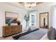Relaxing bedroom with wood floors, a king-size bed, decorative mirror, and plenty of light at 320 Catheys Crk Cir, Wendell, NC 27591