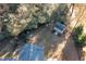 Aerial view of backyard with shed, green chairs, and surrounding trees at 40 Ringneck Ct, Lillington, NC 27546