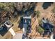 Birds eye view of a single Gathering home with a long driveway and surrounding trees at 40 Ringneck Ct, Lillington, NC 27546