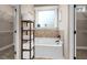 Bathroom with a soaking tub, tile surround and decorative window at 40 Ringneck Ct, Lillington, NC 27546